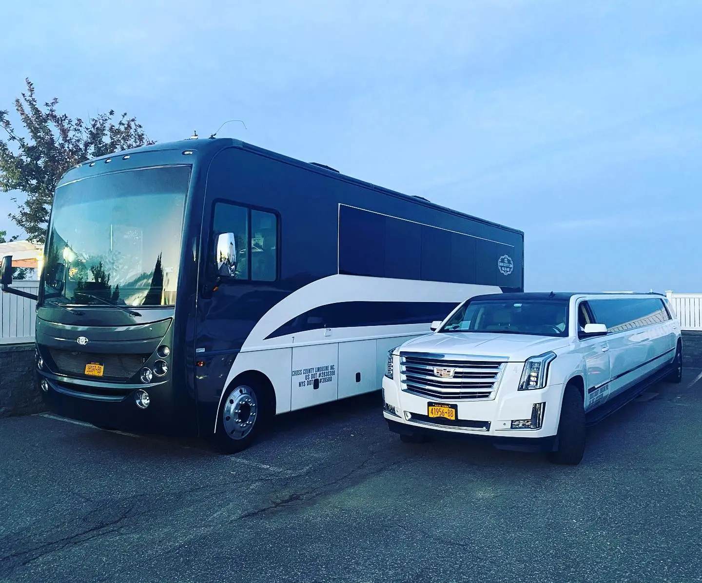 Workhorse luxury limo party bus, specifically a 38-passenger model, paired with a white Cadillac Escalade limousine.