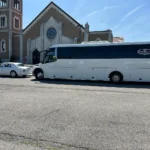 Party bus rental service in Weschester County - white luxury motor coach built on a Freightliner M2 chassis